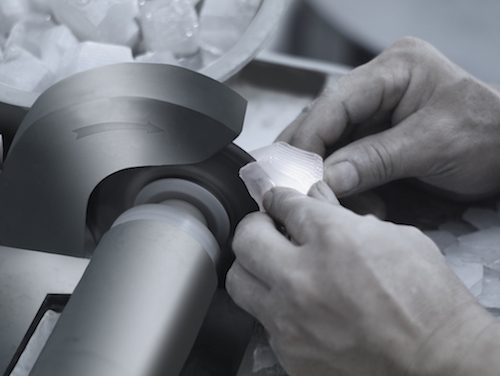 Cubic zirconia stone being shaped on a cutting wheel